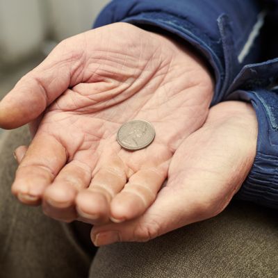 hands of beggar with penny coin begging for money